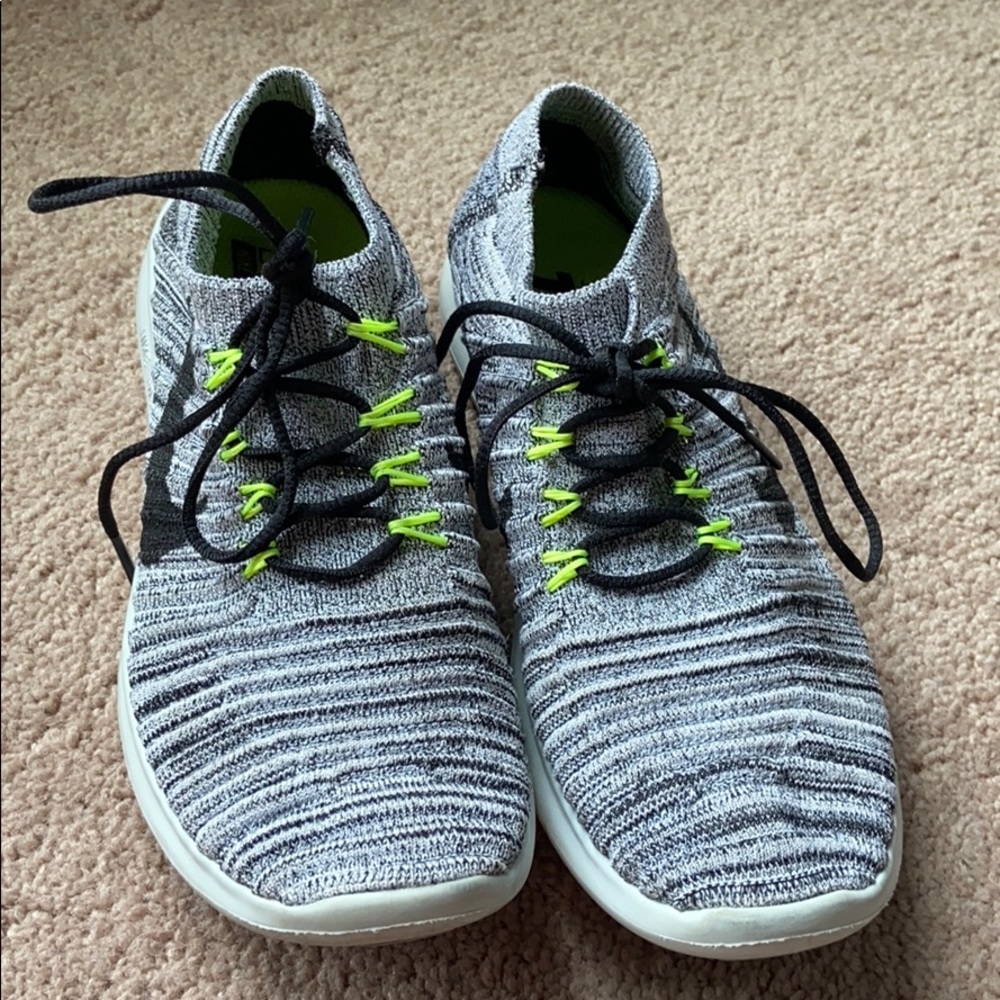 Grey, white, and black Nike Frees